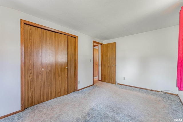 913 N Flora Dr, Mount Pulaski, IL 62548 - unfurnished bedroom featuring carpet floors and a closet