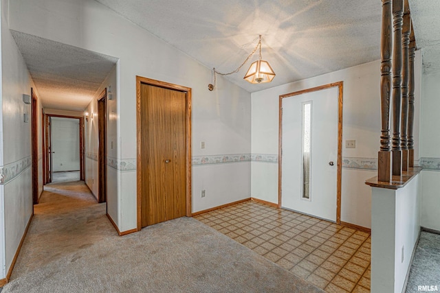 913 N Flora Dr, Mount Pulaski, IL 62548 - foyer entrance featuring a textured ceiling and baseboards