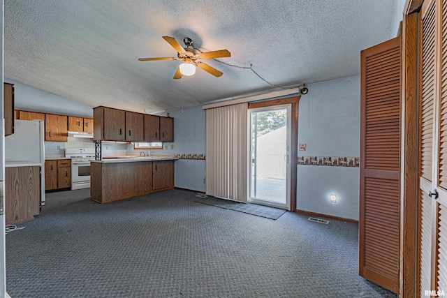 913 N Flora Dr, Mount Pulaski, IL 62548 - kitchen featuring white appliances, a textured ceiling, a peninsula, ceiling fan, and under cabinet range hood