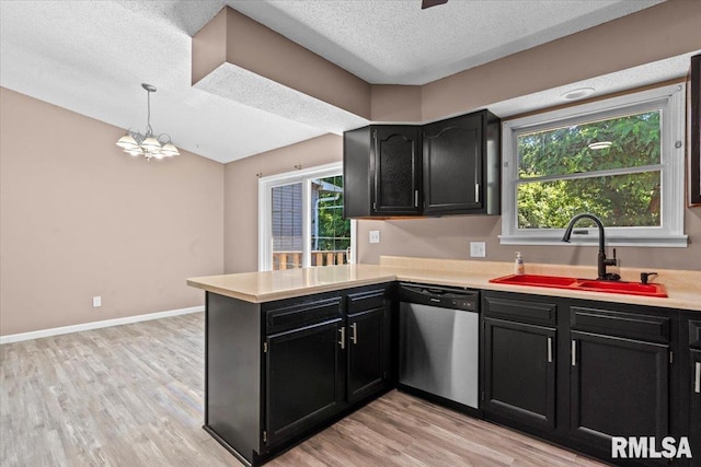 913 Diane Ct, Springfield, IL 62702 - kitchen featuring dishwasher, dark cabinets, a peninsula, light countertops, and a textured ceiling