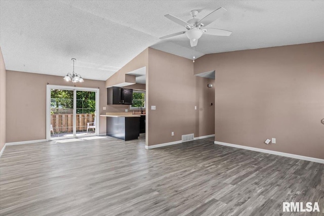 913 Diane Ct, Springfield, IL 62702 - unfurnished living room featuring wood finished floors, a chandelier, a textured ceiling, lofted ceiling, and a ceiling fan