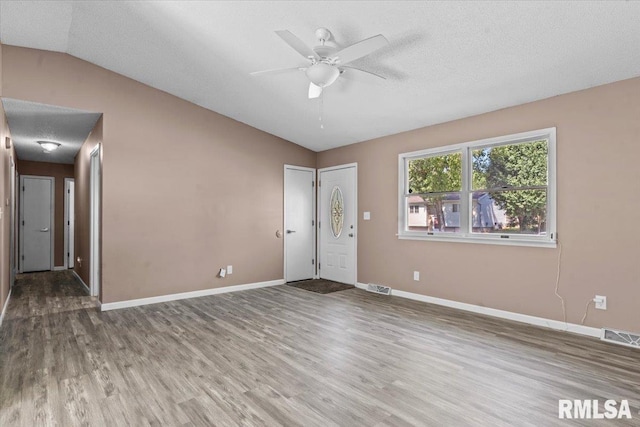 913 Diane Ct, Springfield, IL 62702 - empty room with wood finished floors, vaulted ceiling, ceiling fan, and a textured ceiling