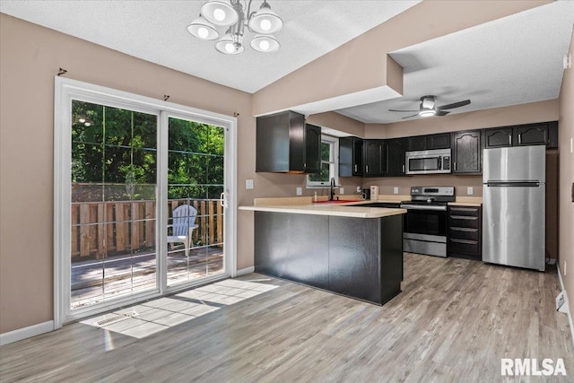 913 Diane Ct, Springfield, IL 62702 - kitchen featuring appliances with stainless steel finishes, light wood-style floors, light countertops, a chandelier, and a textured ceiling