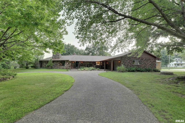 1220 Springdale S Dr, Quincy, IL 62305 - ranch-style home featuring curved driveway, a front yard, a chimney, and stone siding
