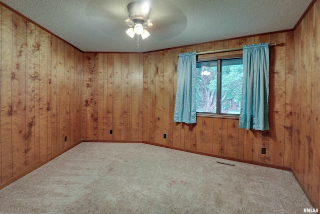 1220 Springdale S Dr, Quincy, IL 62305 - carpeted empty room with a textured ceiling, wooden walls, and ceiling fan