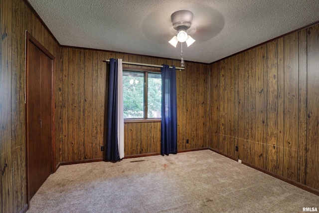 1220 Springdale S Dr, Quincy, IL 62305 - carpeted empty room with a ceiling fan, a textured ceiling, and wooden walls