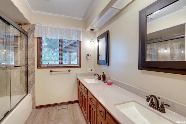 1220 Springdale S Dr, Quincy, IL 62305 - bathroom with double vanity, wood finished floors, ornamental molding, and enclosed tub / shower combo