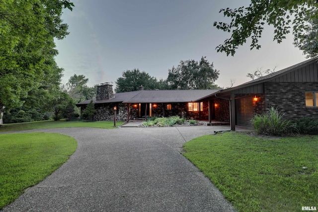 1220 Springdale S Dr, Quincy, IL 62305 - ranch-style house with a front lawn, curved driveway, a chimney, and brick siding
