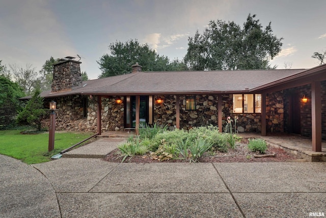 1220 Springdale S Dr, Quincy, IL 62305 - ranch-style home with stone siding, a chimney, and a front lawn