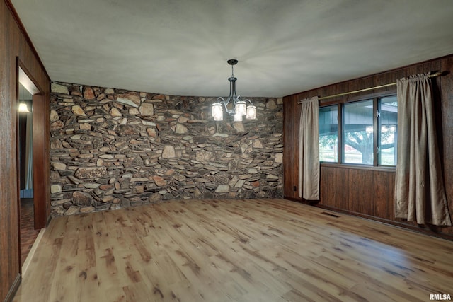 1220 Springdale S Dr, Quincy, IL 62305 - unfurnished dining area featuring wood finished floors, a chandelier, and wood walls