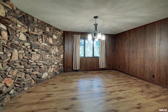 1220 Springdale S Dr, Quincy, IL 62305 - unfurnished dining area featuring a chandelier, wood finished floors, and wooden walls