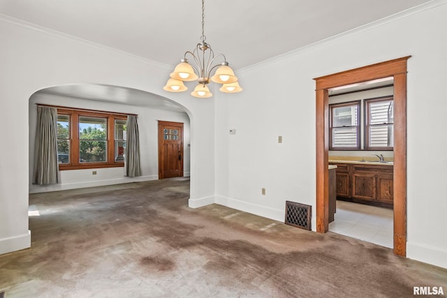 417 E Keys Ave, Springfield, IL 62702 - unfurnished dining area with arched walkways, a chandelier, carpet floors, and crown molding