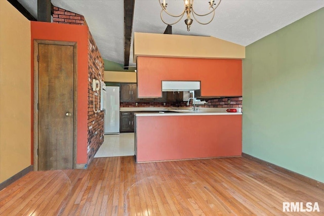 5016 Kinsinger Ln, Pleasant Plains, IL 62677 - kitchen featuring freestanding refrigerator, light wood-type flooring, vaulted ceiling, tasteful backsplash, and a peninsula