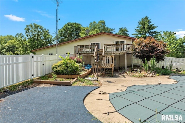 5016 Kinsinger Ln, Pleasant Plains, IL 62677 - rear view of house featuring a garden, a patio, a fenced backyard, and a wooden deck