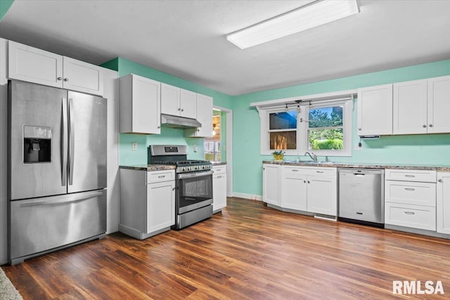 7971 Mechanicsburg Rd, Springfield, IL 62707 - kitchen featuring stainless steel appliances, under cabinet range hood, white cabinetry, and dark wood-style floors