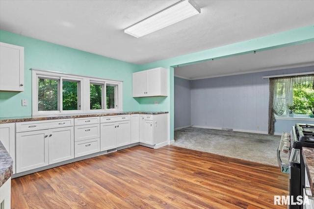7971 Mechanicsburg Rd, Springfield, IL 62707 - kitchen featuring stainless steel gas range, white cabinetry, and light wood-style floors