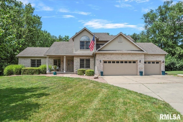 345 Country Towne Rd, Springfield, IL 62712 - traditional home with a front yard, a garage, driveway, brick siding, and a porch