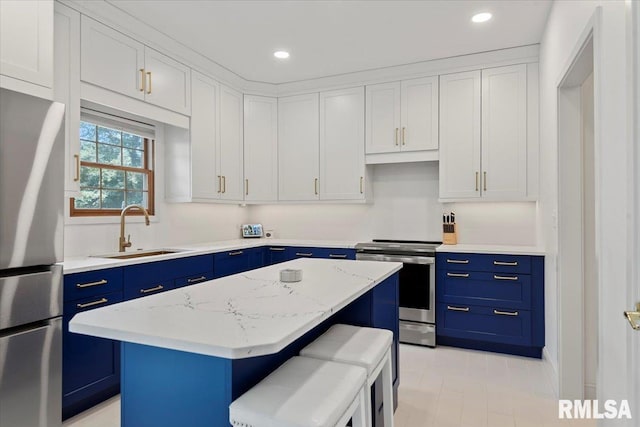 345 Country Towne Rd, Springfield, IL 62712 - kitchen featuring blue cabinets, stainless steel appliances, a kitchen island, recessed lighting, and a kitchen breakfast bar