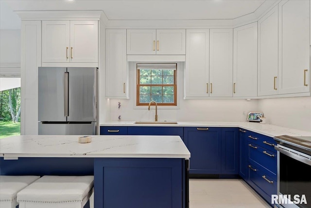 345 Country Towne Rd, Springfield, IL 62712 - kitchen featuring stainless steel appliances, blue cabinetry, plenty of natural light, and white cabinetry