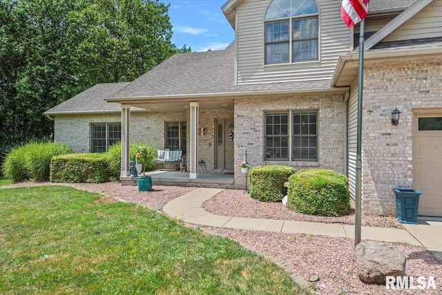 345 Country Towne Rd, Springfield, IL 62712 - view of front of house featuring brick siding, covered porch, a front lawn, and roof with shingles