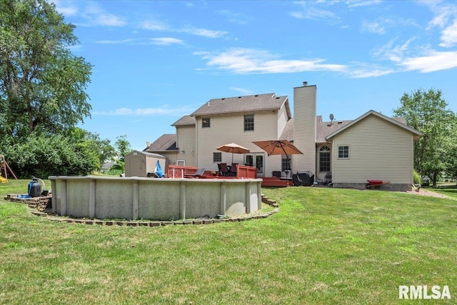 345 Country Towne Rd, Springfield, IL 62712 - back of house with an outdoor pool, a chimney, a lawn, and a wooden deck
