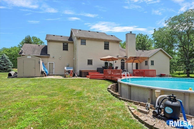 345 Country Towne Rd, Springfield, IL 62712 - rear view of property featuring a shed, a wooden deck, a chimney, an outdoor pool, and a yard