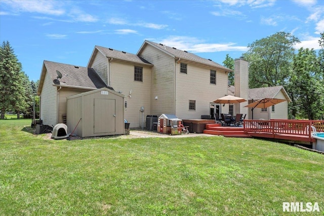 345 Country Towne Rd, Springfield, IL 62712 - back of house featuring a storage unit, a hot tub, a wooden deck, a lawn, and a chimney