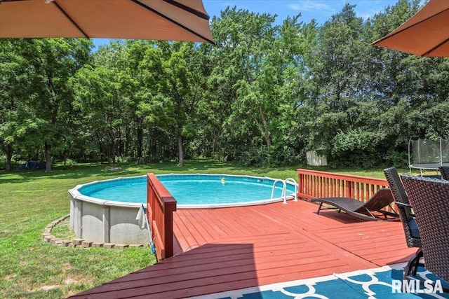 345 Country Towne Rd, Springfield, IL 62712 - swimming pool featuring a trampoline, a wooden deck, a yard, and view of scattered trees