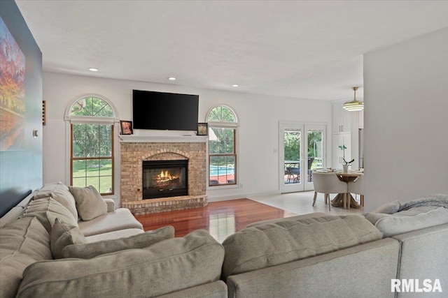 345 Country Towne Rd, Springfield, IL 62712 - living room featuring wood finished floors, a brick fireplace, and recessed lighting