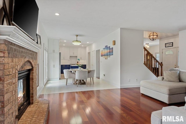 345 Country Towne Rd, Springfield, IL 62712 - living room featuring stairs, light wood-type flooring, a fireplace, and recessed lighting