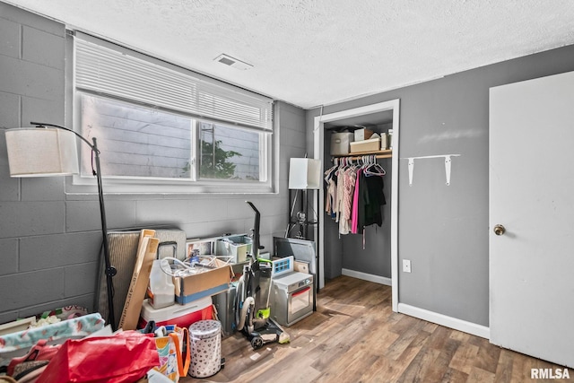 2208 E Black Ave, Springfield, IL 62702 - bedroom with wood finished floors, a textured ceiling, and concrete block wall