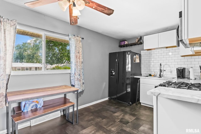 2208 E Black Ave, Springfield, IL 62702 - kitchen with black refrigerator with ice dispenser, backsplash, a ceiling fan, white cabinetry, and light stone countertops
