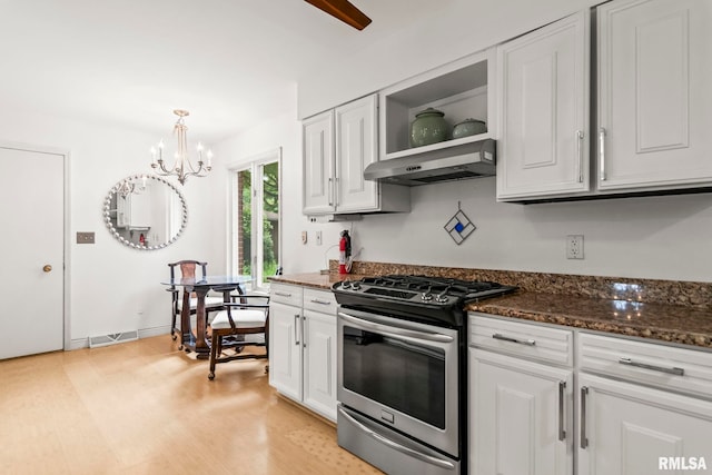 1613 Denison Dr, Springfield, IL 62704 - kitchen featuring stainless steel range with gas stovetop, range hood, a chandelier, white cabinetry, and dark stone counters