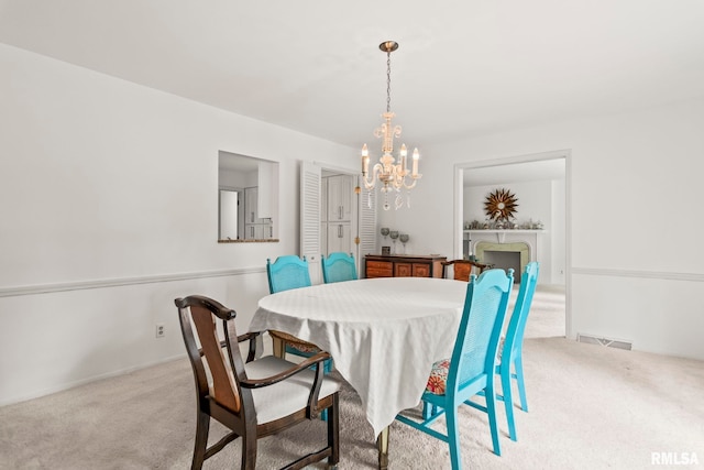 1613 Denison Dr, Springfield, IL 62704 - dining room with a chandelier, carpet, and a fireplace