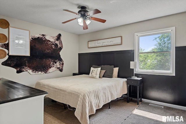 84 Chukar Dr, Chatham, IL 62629 - carpeted bedroom with a ceiling fan and a textured ceiling