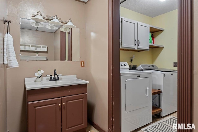 84 Chukar Dr, Chatham, IL 62629 - laundry room with separate washer and dryer, cabinet space, and a textured ceiling