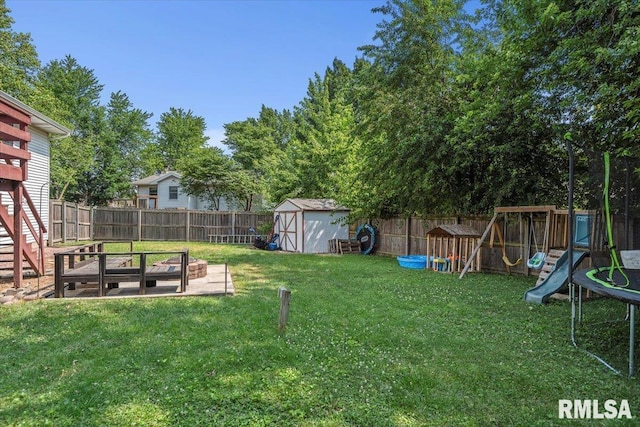 84 Chukar Dr, Chatham, IL 62629 - fenced backyard with a trampoline, a storage unit, and a playground