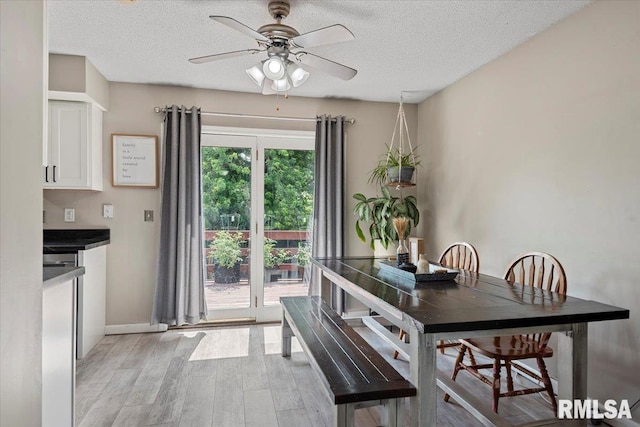 84 Chukar Dr, Chatham, IL 62629 - dining area with light wood finished floors, ceiling fan, and a textured ceiling