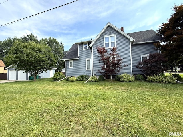 833 Willard St, Galesburg, IL 61401 - view of home's exterior with a yard, a chimney, a garage, and an outdoor structure