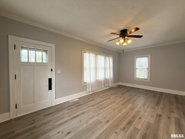 833 Willard St, Galesburg, IL 61401 - entryway with wood-type flooring, plenty of natural light, a textured ceiling, a ceiling fan, and crown molding