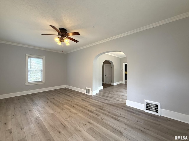 833 Willard St, Galesburg, IL 61401 - empty room with a ceiling fan, crown molding, wood finished floors, arched walkways, and a textured ceiling