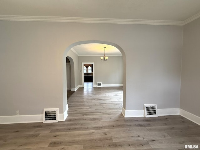 833 Willard St, Galesburg, IL 61401 - empty room with ornamental molding, arched walkways, wood finished floors, and a chandelier