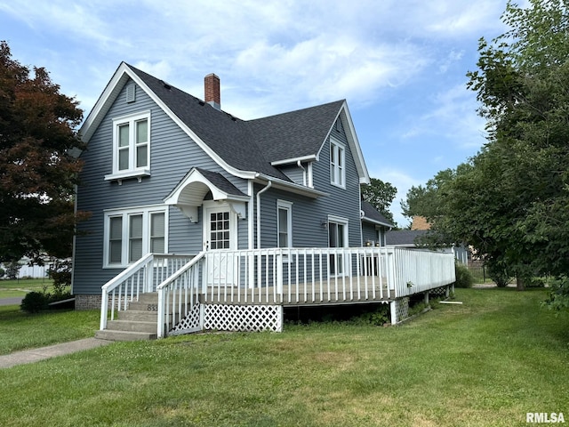 833 Willard St, Galesburg, IL 61401 - view of front of home with a chimney, a front yard, a shingled roof, and a wooden deck