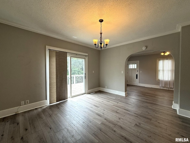 833 Willard St, Galesburg, IL 61401 - empty room with a textured ceiling, arched walkways, ornamental molding, a chandelier, and wood finished floors