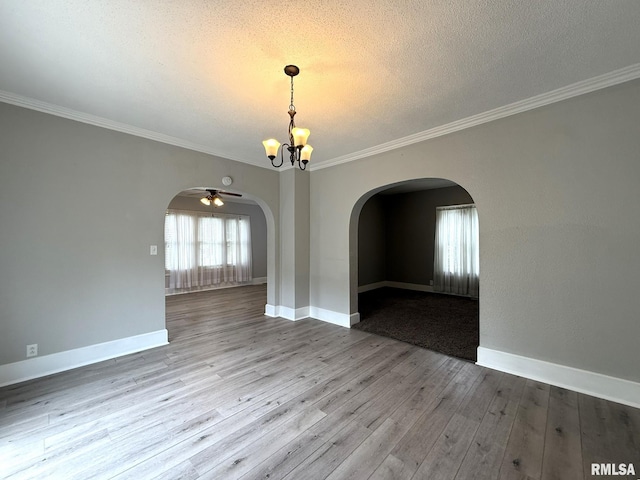 833 Willard St, Galesburg, IL 61401 - unfurnished room with arched walkways, a chandelier, wood finished floors, ornamental molding, and a ceiling fan
