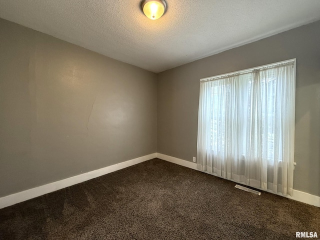 833 Willard St, Galesburg, IL 61401 - spare room with dark colored carpet and a textured ceiling
