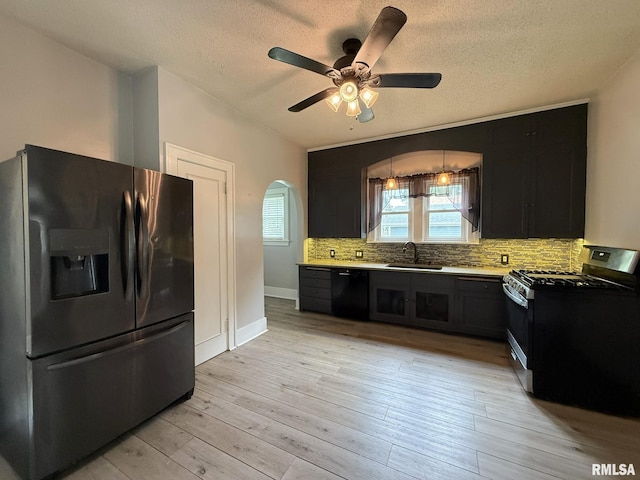 833 Willard St, Galesburg, IL 61401 - kitchen with fridge with ice dispenser, stainless steel range with gas cooktop, dishwasher, dark cabinets, and a textured ceiling