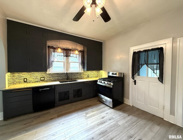 833 Willard St, Galesburg, IL 61401 - kitchen with stainless steel range with gas stovetop, black dishwasher, dark cabinets, a textured ceiling, and tasteful backsplash