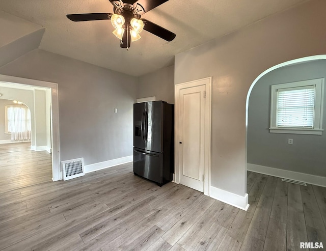 833 Willard St, Galesburg, IL 61401 - spare room featuring arched walkways, ceiling fan, healthy amount of natural light, and wood finished floors