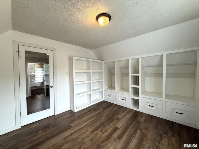 833 Willard St, Galesburg, IL 61401 - empty room featuring a textured ceiling, vaulted ceiling, dark wood-type flooring, and built in shelves